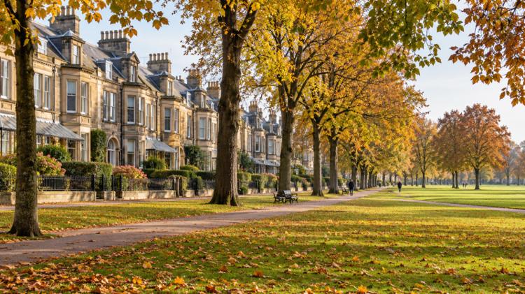 Honey-coloured Victorian sandstone terraces facing the wide open grass of the Stray in Harrogate on an autumn morning